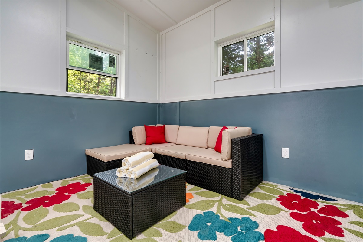 Clean towels and comfortable seating await! This versatile space is a great spot to transition after using the pool.