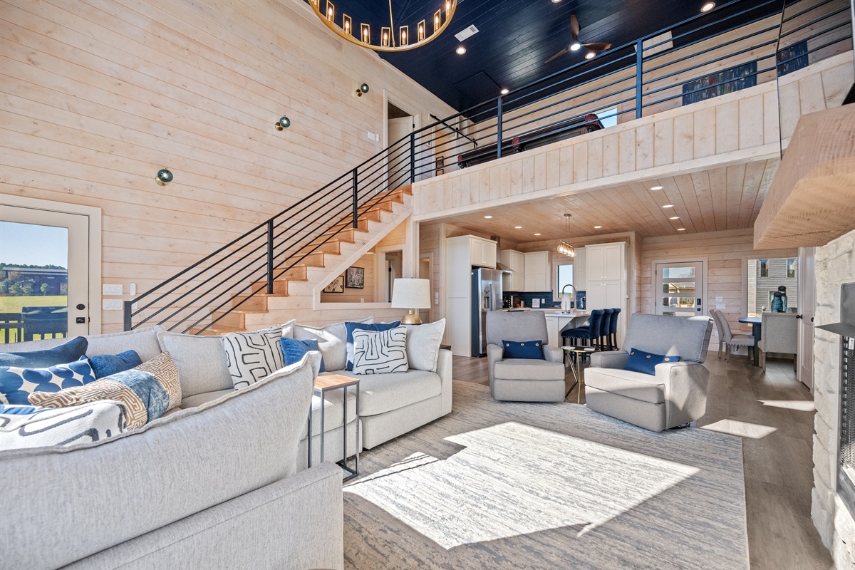 Open-concept living area with vaulted ceilings, modern furnishings, and plenty of natural light.