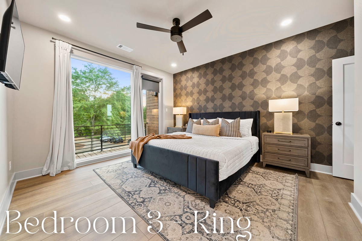 The king-sized bed, dressed in luxurious bedding and complemented by chic pillows, exudes comfort and elegance.