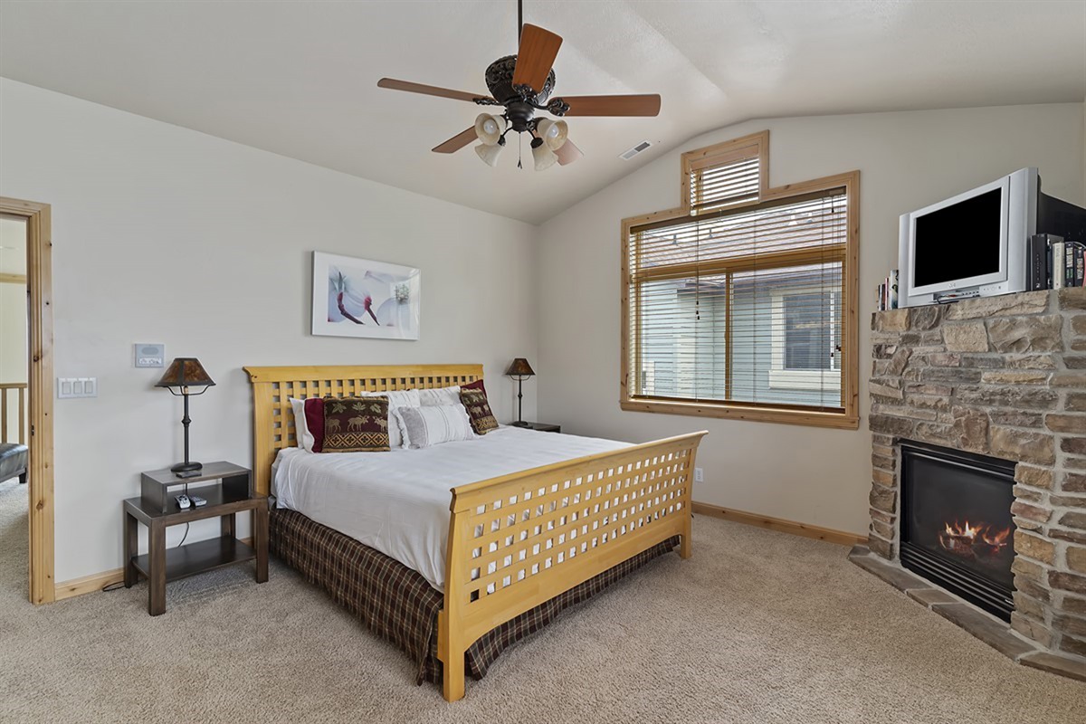 Serene primary bedroom retreat featuring a fireplace, soft textures, and peaceful ambiance for restful nights.