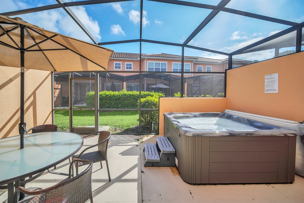 Lanai with hot tub and dining area