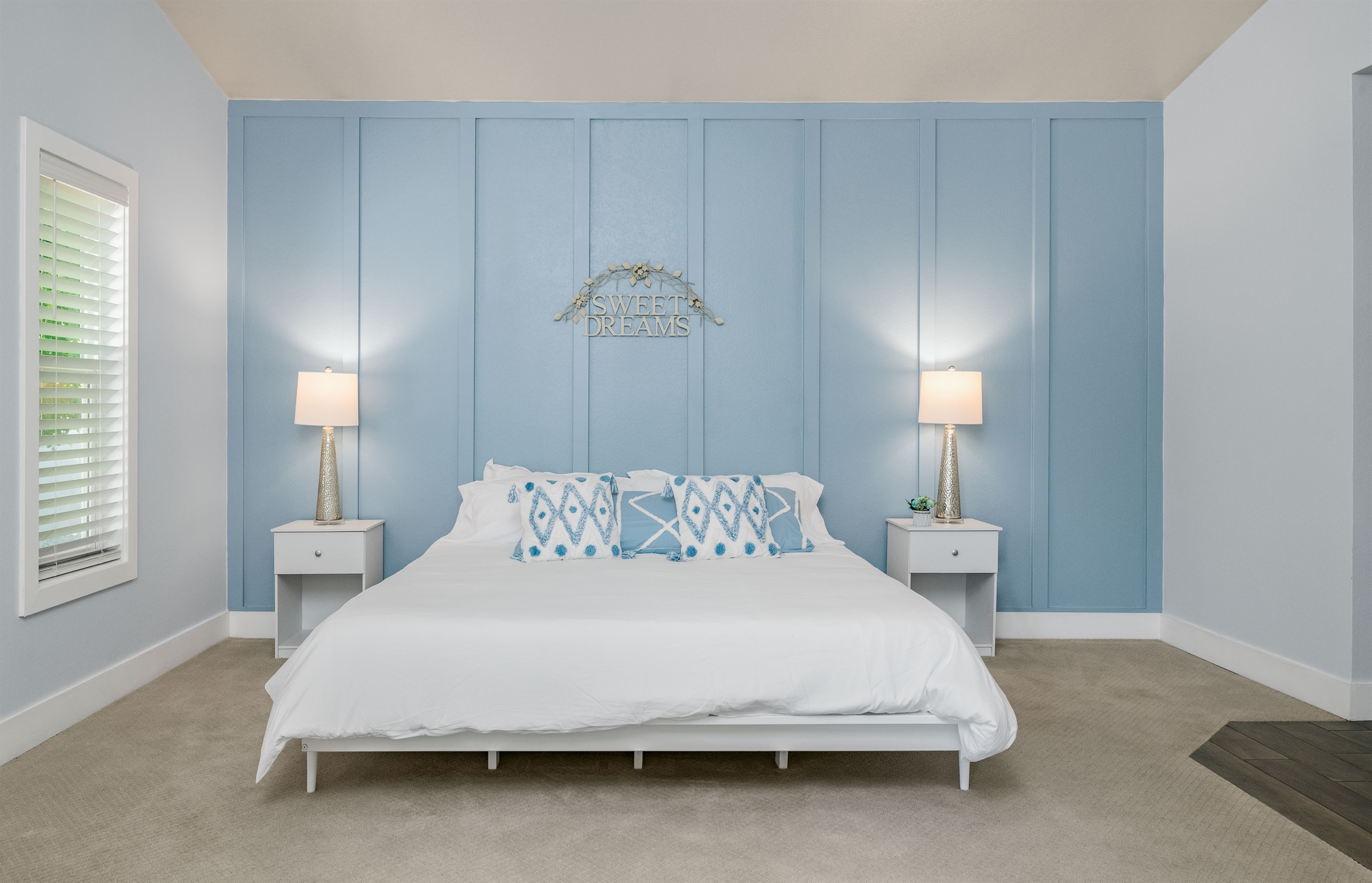 Stretch out in the spacious primary bedroom with a king bed, soft lighting, and room for a Pack ‘n Play for family comfort.