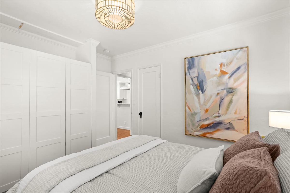 Bedroom 1 features a comfortable queen bed, soft linens, calming decor, and a relaxing space to unwind and recharge.