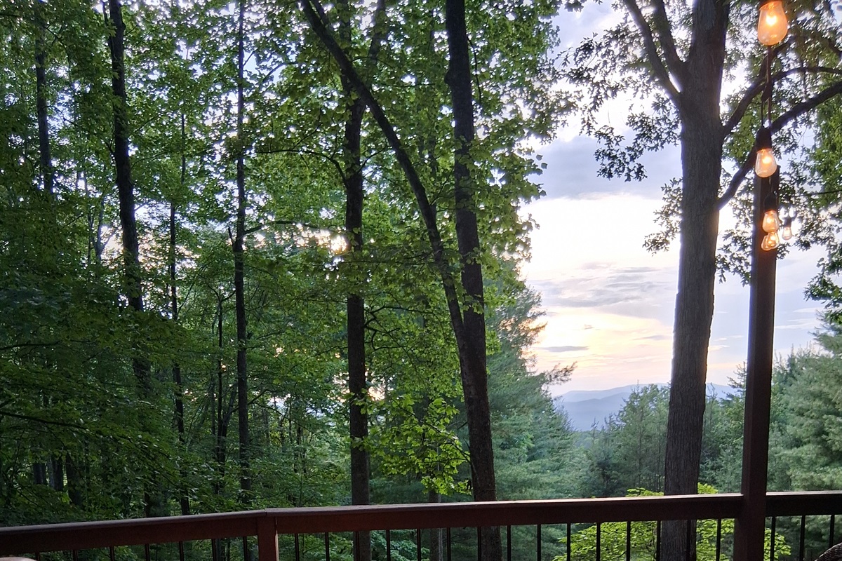 Gas burning firepit on front deck with mountain view.