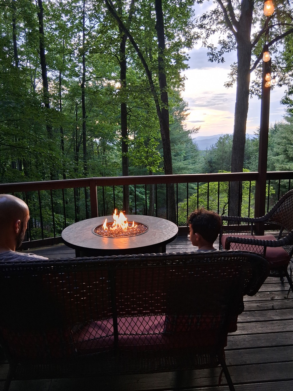 Gas burning firepit on front deck with mountain view.