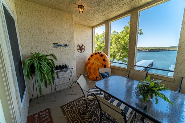 Private covered patio with dining table, lake views, and a relaxing indoor-outdoor feel