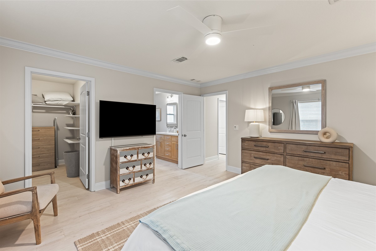 Bedroom 1 (Primary): A restful sanctuary featuring a King-sized bed, smart TV, generous walk-in closet, and serene decor.