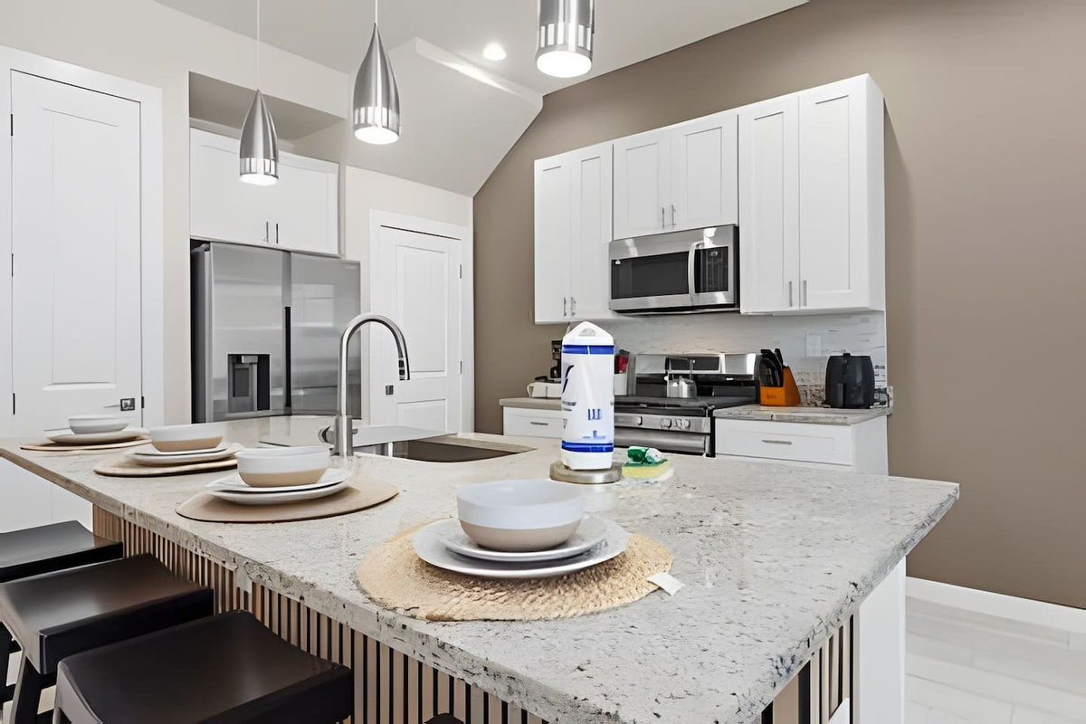 Gather around the kitchen island—your perfect spot for casual meals and conversation.