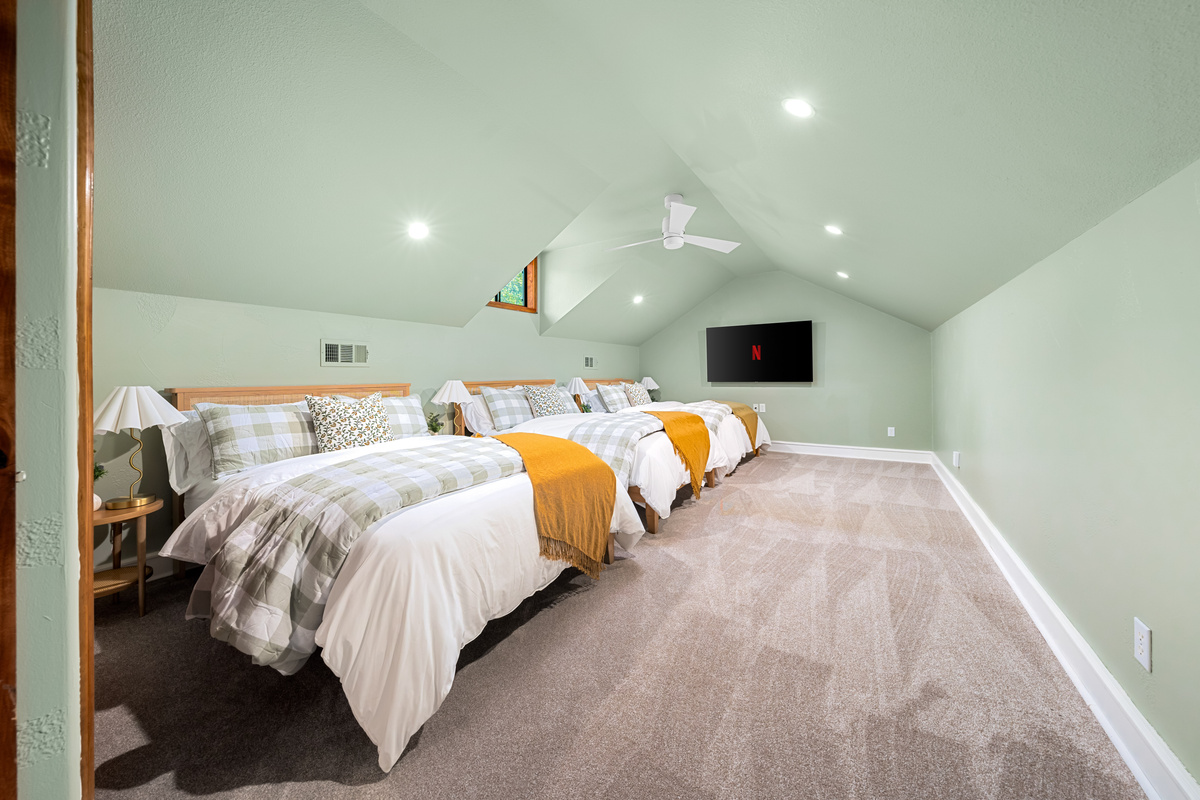 Spacious accommodations designed for families and groups traveling together in this upstairs bedroom featuring 3 queen-size beds.