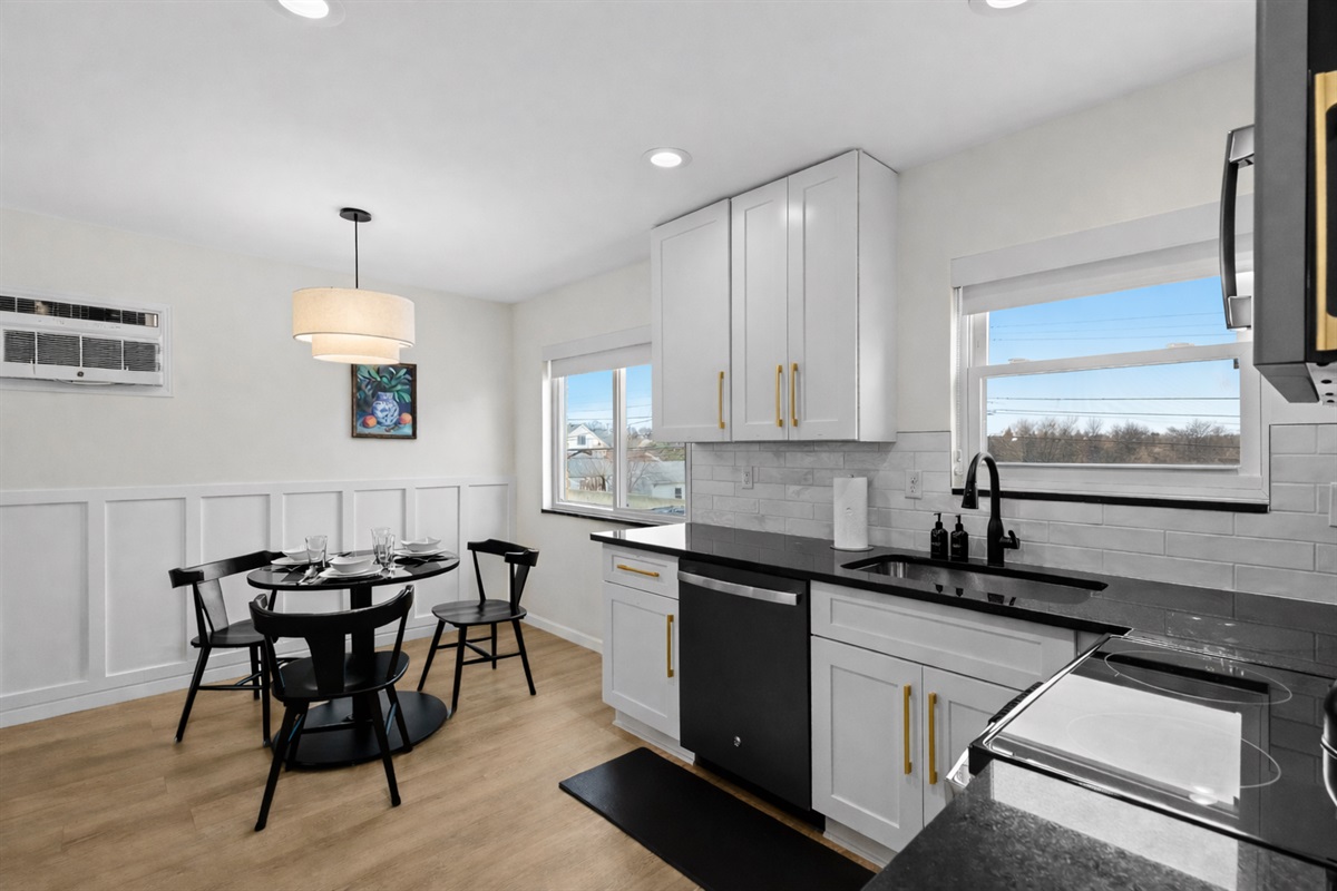 Bright kitchen and dining area with modern finishes, ample counter space, and natural light—perfect for cooking, dining, and everyday comfort.