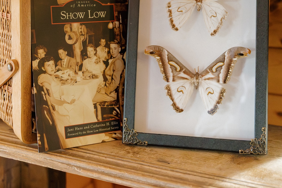 Curated decor celebrates Show Low's heritage at Poppywood Pines. Thoughtful touches and local history books create an authentic White Mountains experience. This pet-friendly cabin blends rustic charm with modern comfort for your Arizona mountain getaway.