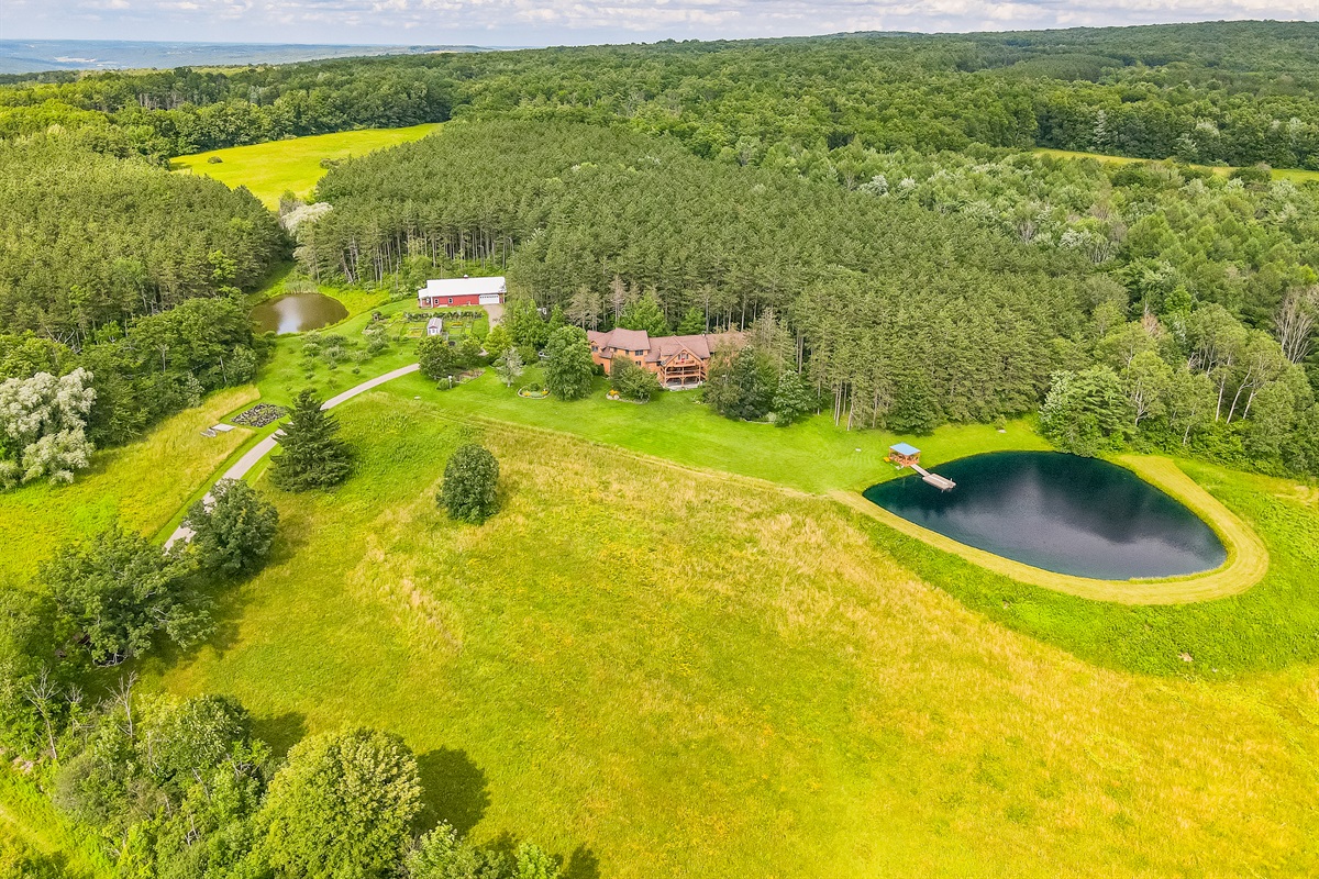 Escape to your own private retreat surrounded by rolling hills and forest. This stunning property features a spring-fed pond with a dock, wide-open meadows, and total privacy—perfect for relax
