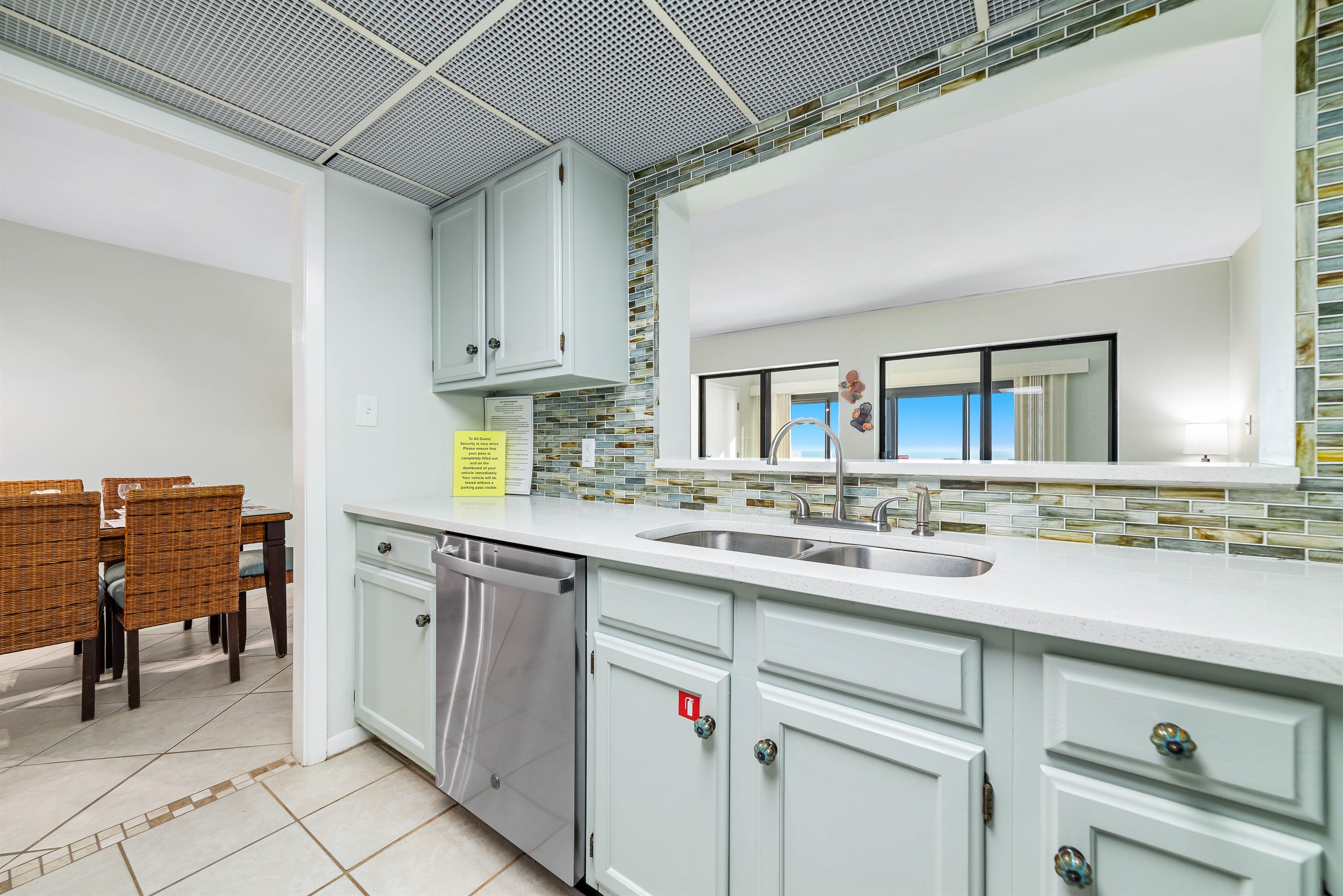 Updated kitchen with stainless steel appliances, quartz countertops, and a contemporary backsplash, offering both functionality and aesthetic appeal.