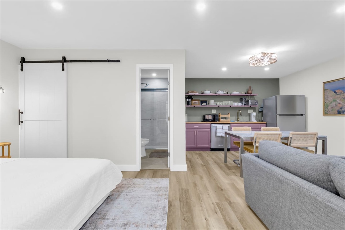 Spacious and bright 500 sq ft studio with a king bed, comfortable sofa, TV, and fully equipped kitchen; ideal for extended stays or weekend getaways.