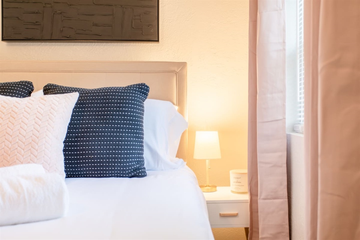 Bed Pillows with side table and lamp.