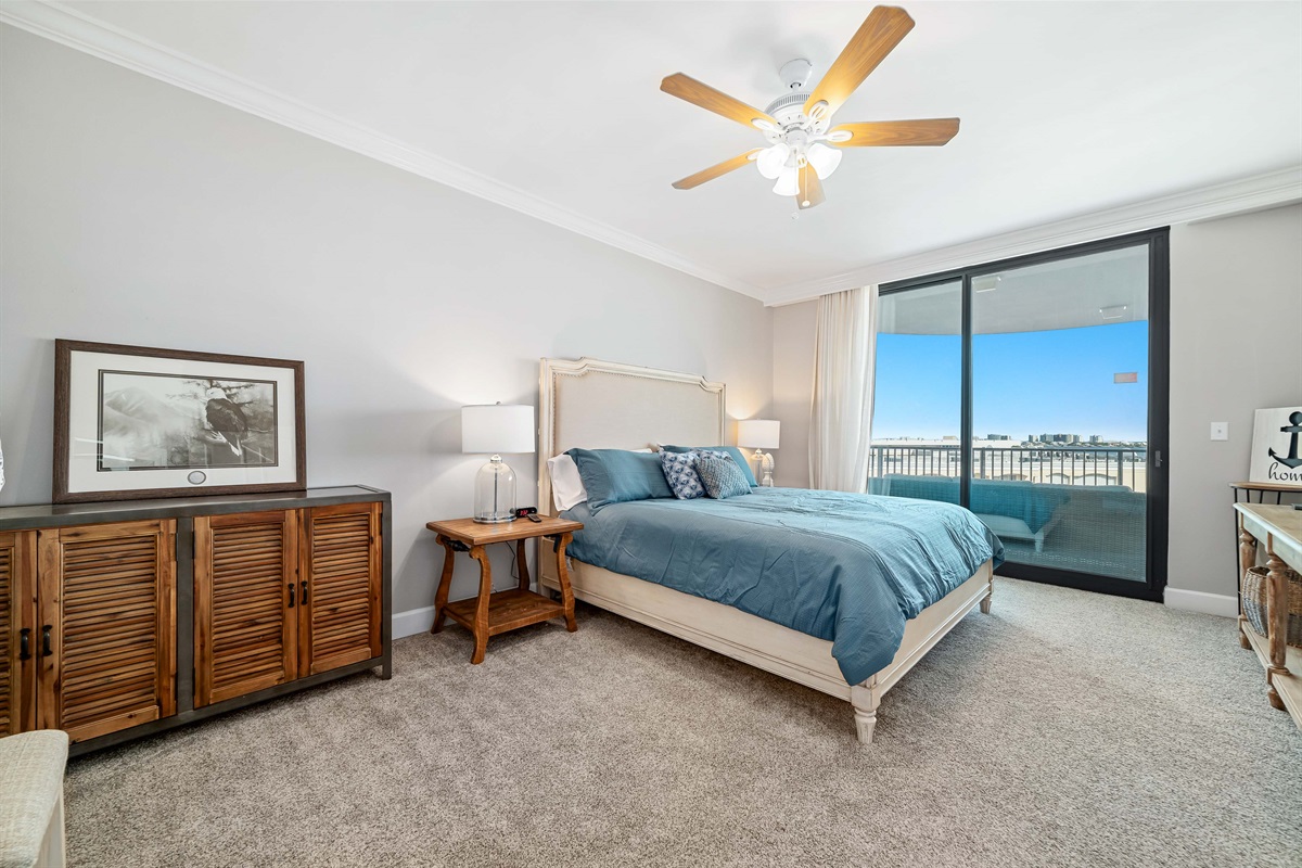Wake up to stunning water views in this beautifully appointed master bedroom. Seamlessly blending indoor and outdoor living, the expansive sliding doors open to a private balcony, creating a serene and luxurious retreat.