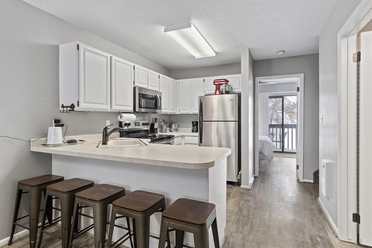 Fully equipped kitchen with breakfast bar—everything you need for home-cooked meals.