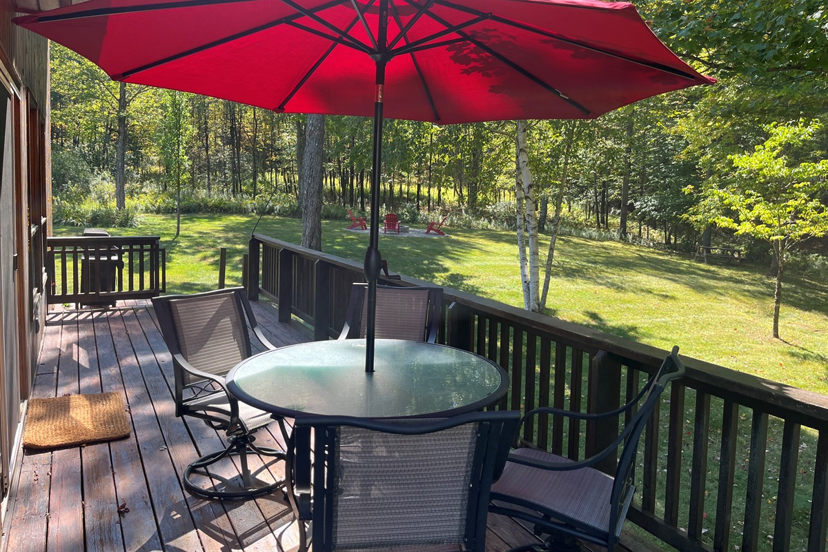 Outdoor dining with firepit beyond