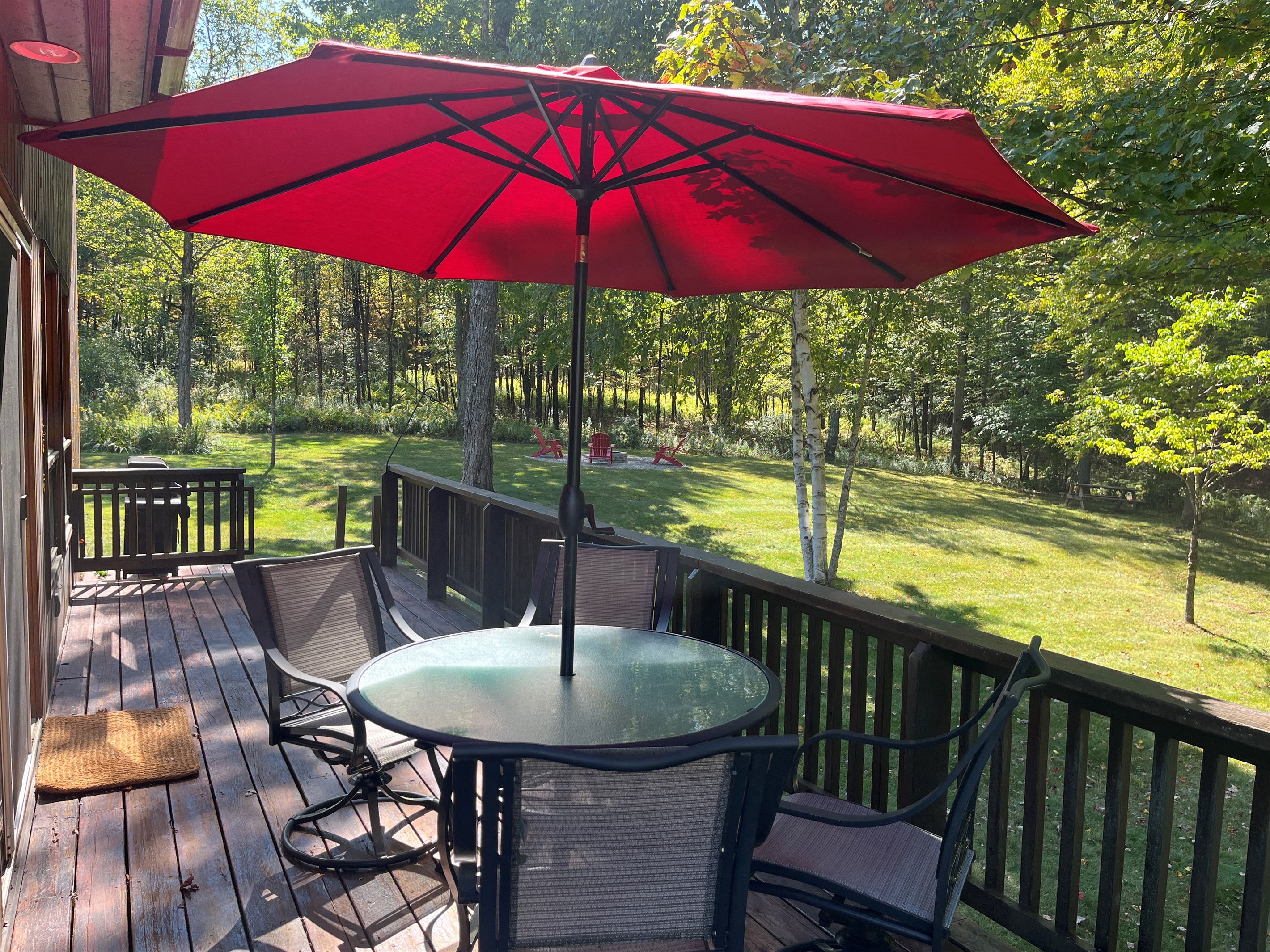 Outdoor dining with firepit beyond