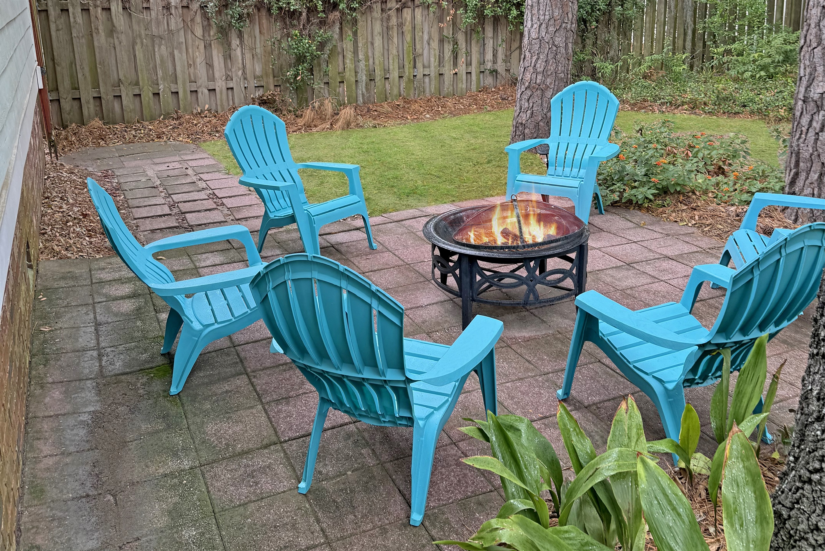 Cozy up by the firepit in the backyard, perfect for relaxing evenings under the stars at Pointe North Oasis.
