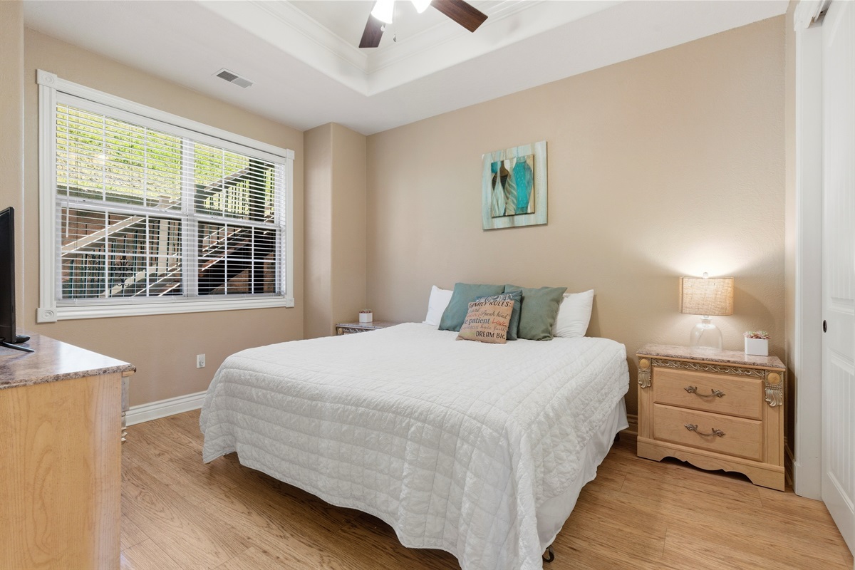 Unwind in this cozy queen bedroom with natural light and soft bedding.