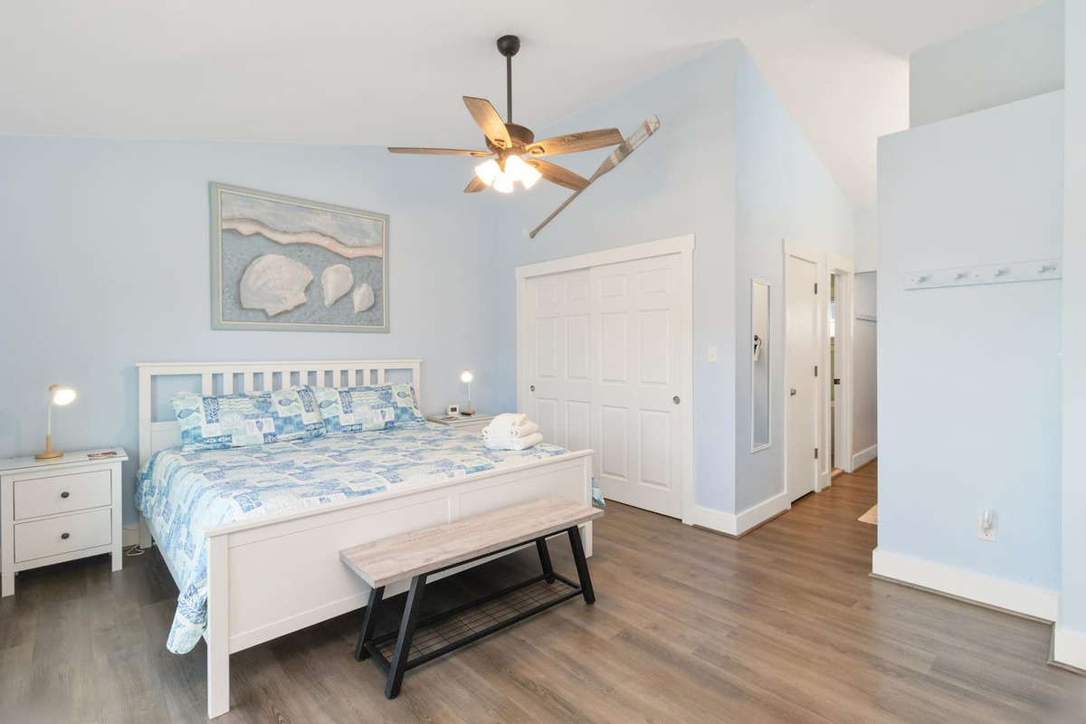 Your top-level king suite comes with a private deck, en-suite bath, and in-unit laundry &mdash; the best room in the house.