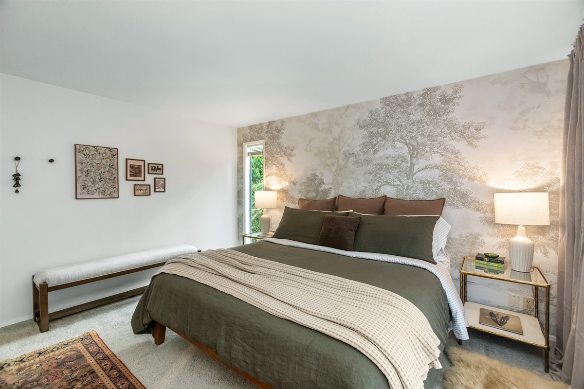 Luxury linens, tasteful murals, and artwork elevate the design of bedrooms throughout.