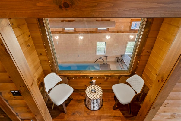 Grand Parent's Nook located in the main living room  with Indoor Heated Pool Views and Natural Light.