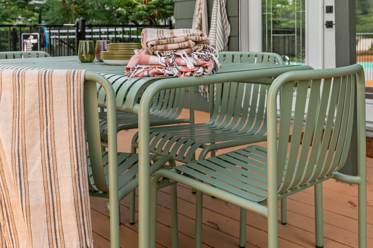 The outdoor table offers seating for six, making it a perfect spot to gather for meals, games, or evening conversations under the open sky.