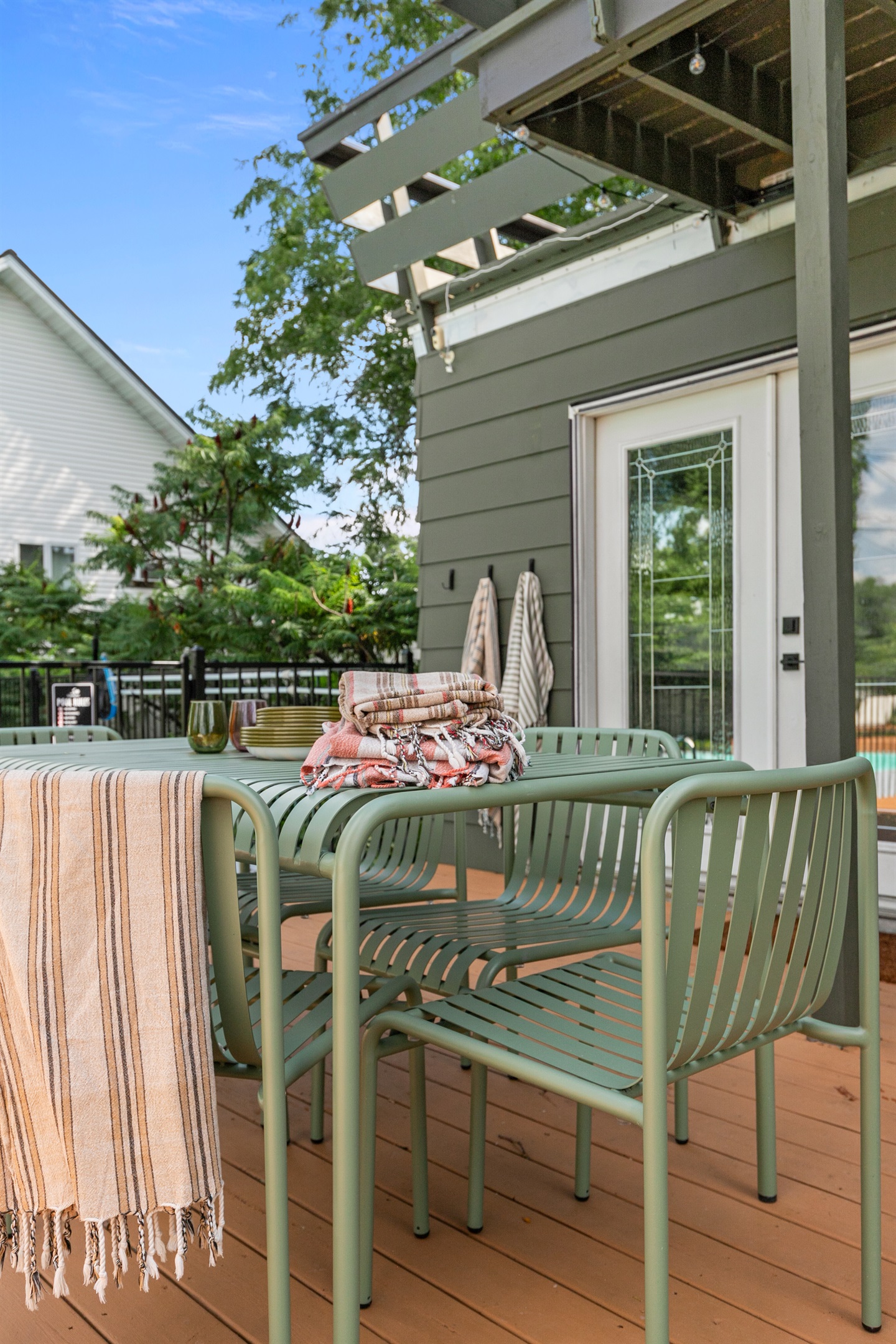 The outdoor table offers seating for six, making it a perfect spot to gather for meals, games, or evening conversations under the open sky.