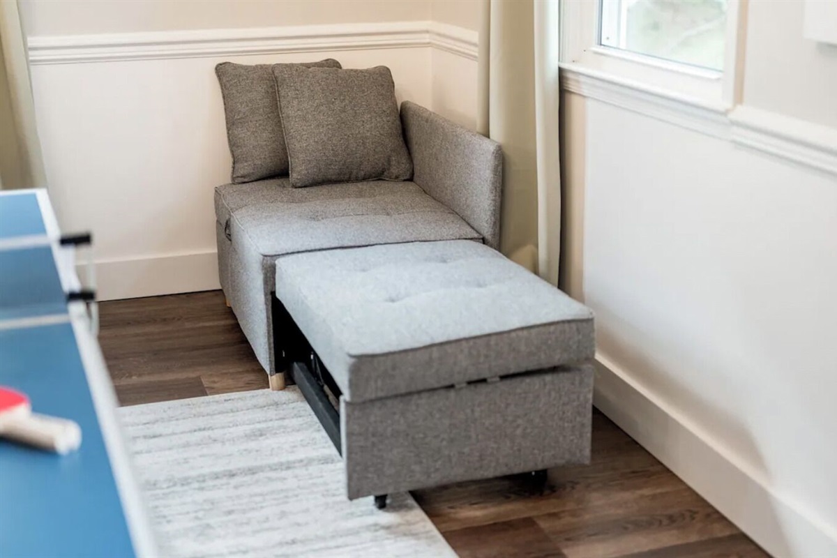 This corner chair converts into a small bed for a child.