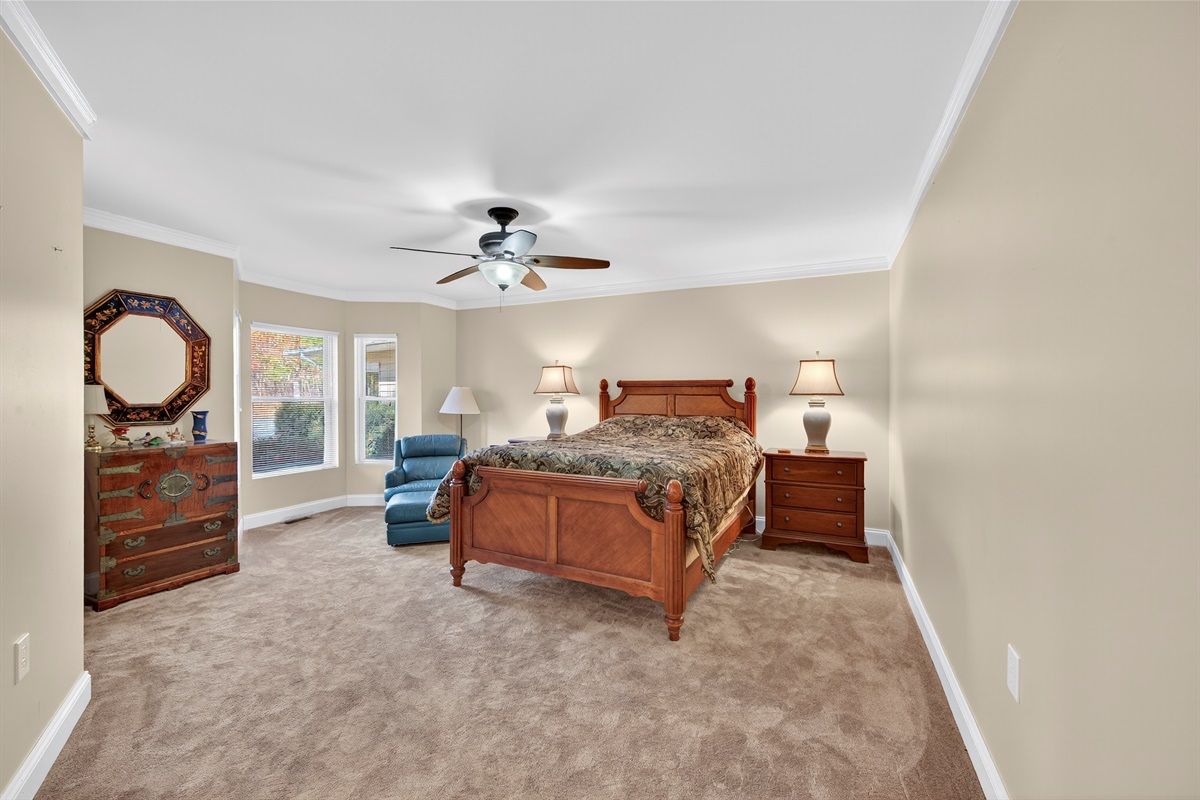 Peaceful and spacious guest room with soft lighting and relaxing tones.