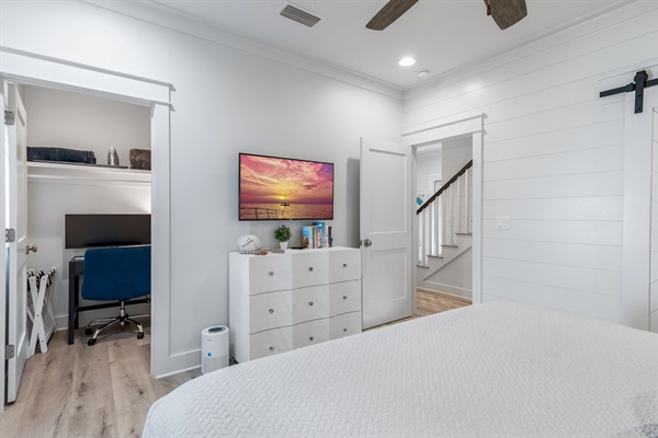 Dedicated Workspace - Tucked off the first-floor king suite, this private workspace features a small window, door, desk, comfortable chair, large monitor, docking station, keyboard, and a mouse—ideal for remote work while enjoying your beach getaway.