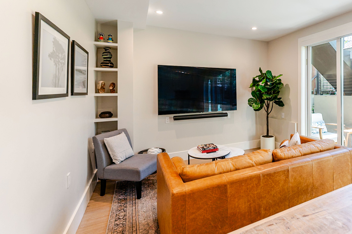 Comfy living room with 75" NeoQLED 4k Smart TV, plush leather sofa with modern queen sleeper option
