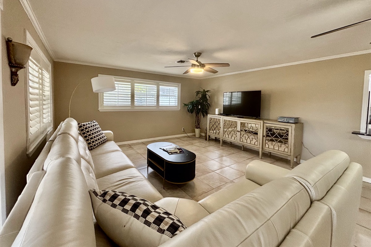 Our expansive rear living room has an abundance of seating and cozy nooks, as well as a comfortable couch with recliners.
