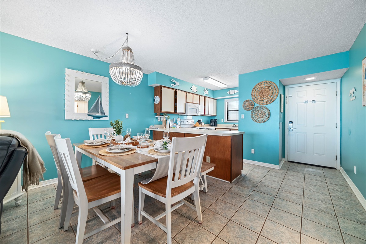 Dine in style with ample space for everyone. This inviting dining area features a charming table for family meals, complemented by additional seating at the convenient breakfast bar.