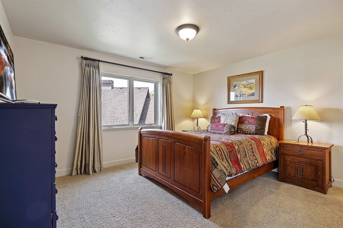 This spacious queen bedroom is perfect for guests