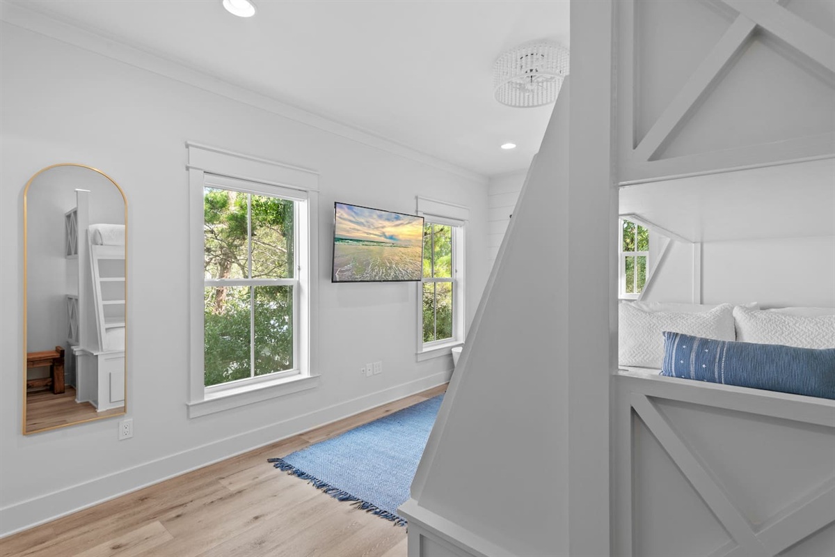 Spacious 2nd level twins over queens bunk room with full ensuite bathroom, tiled shower with tub, and a large vanity.