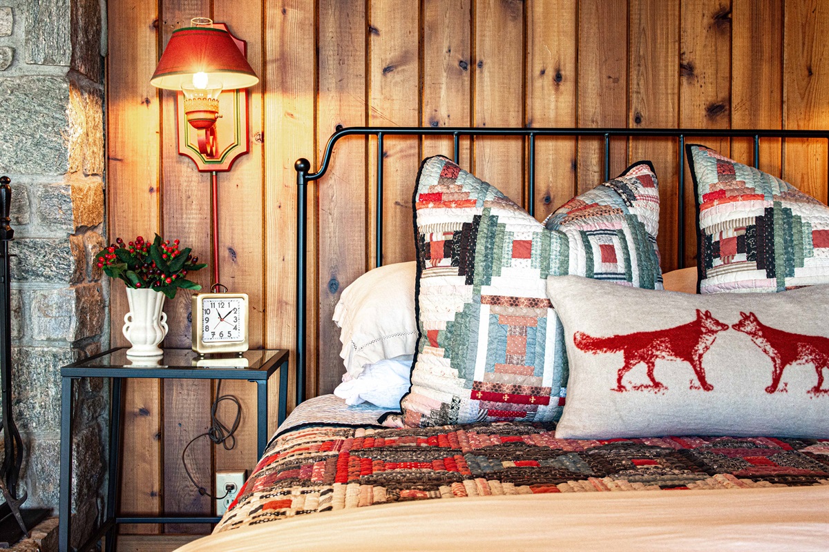 Thoughtful details bring character to the primary bedroom, from layered textiles to custom touches that reflect the cabin’s heritage and cozy mountain style.