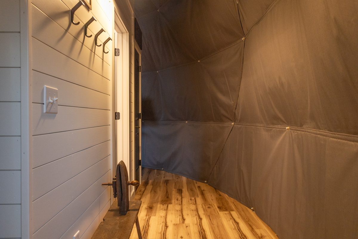 standing just inside the entrance door looking to the right. The bathroom is through the doorway in the center of the photo. Go past that door and around the corner and you will see the stairway to the loft.
