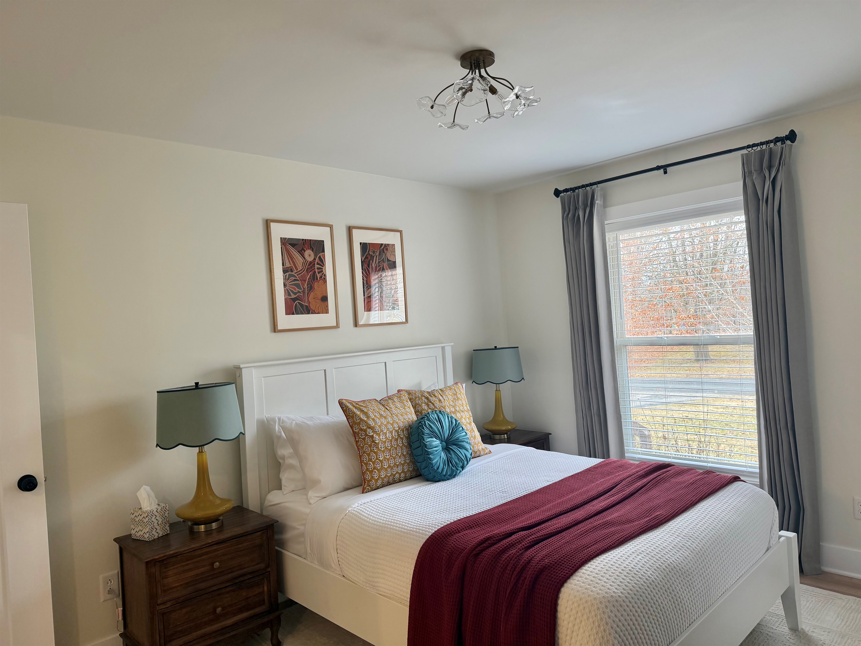 Comfortable bedroom featuring a plush queen bed with professionally cleaned linens, blackout curtains, and a noise machine for a restful night’s sleep. Includes a convenient attached ¾ bath for added privacy and ease