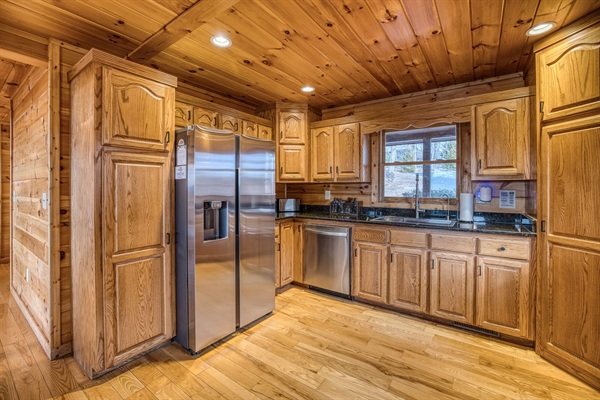 Fully stocked kitchen with low tox features like reverse osmosis water filter under the kitchen sink and attached to the fridge water, stainless steel pots and pans, glass and ceramic bakeware, stainless and silicone cooking utensils, and more!