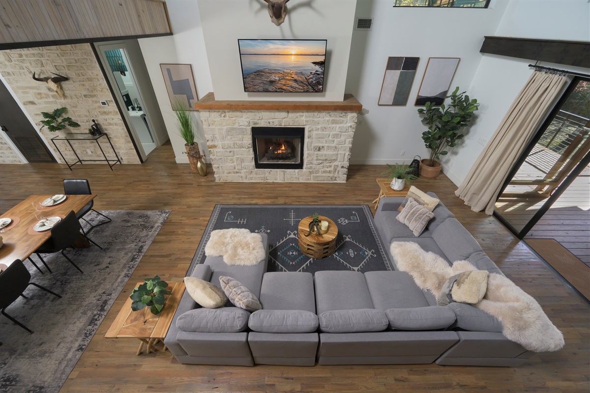 Where everyone comes together — open living anchored by a statement fireplace and warm, inviting textures