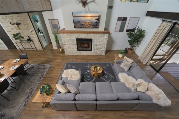 Where everyone comes together — open living anchored by a statement fireplace and warm, inviting textures