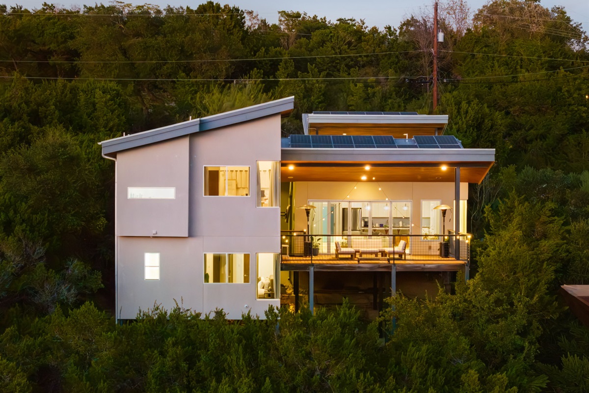 Warm evening views of the home surrounded by nature