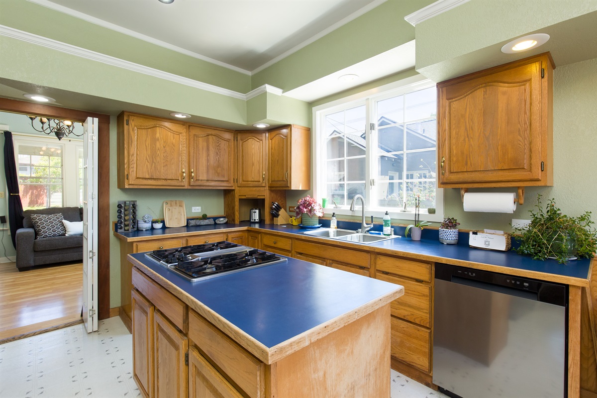Kitchen wide angle showing cabinetry, countertops, and appliances