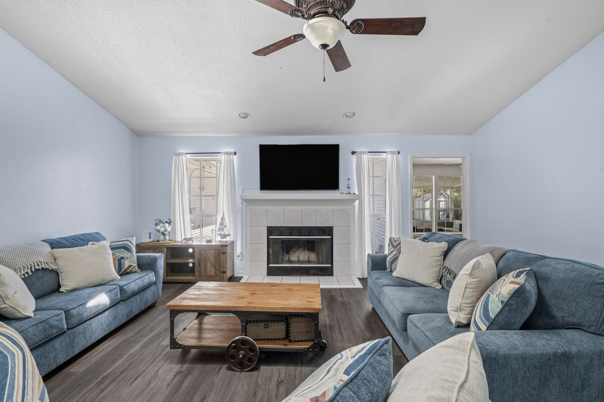 Gather around the fireplace on soft denim-blue sofas, perfect for movie nights or quiet evenings in.
