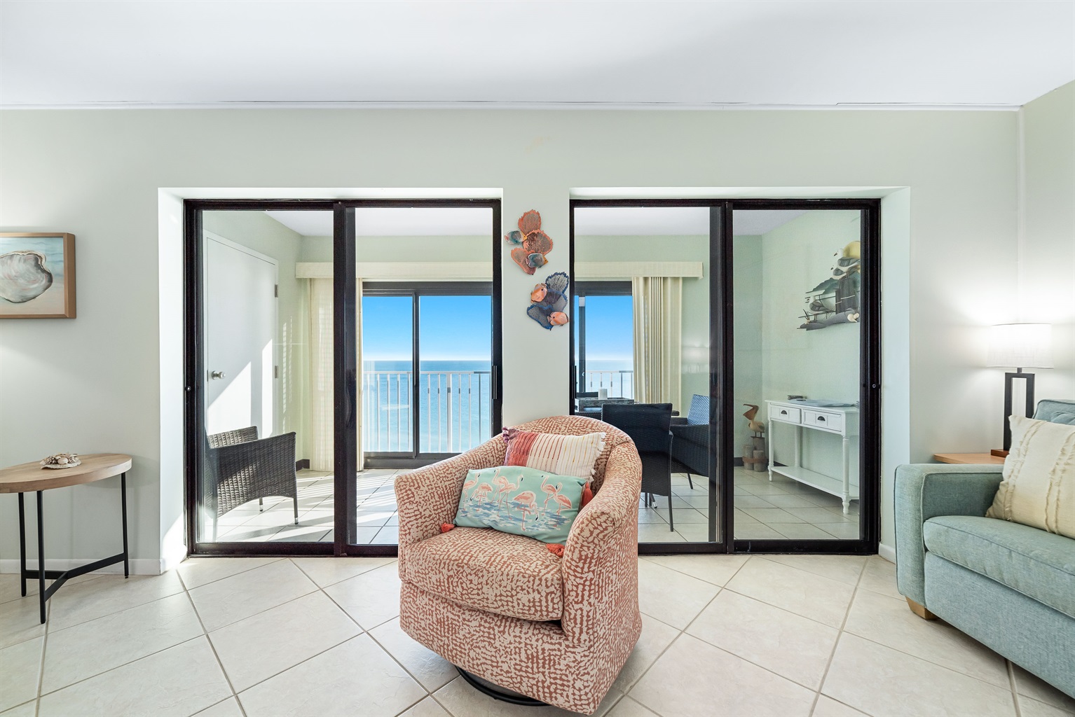 A comfortable living area designed for relaxation, featuring a stylish swivel armchair and panoramic ocean vistas.