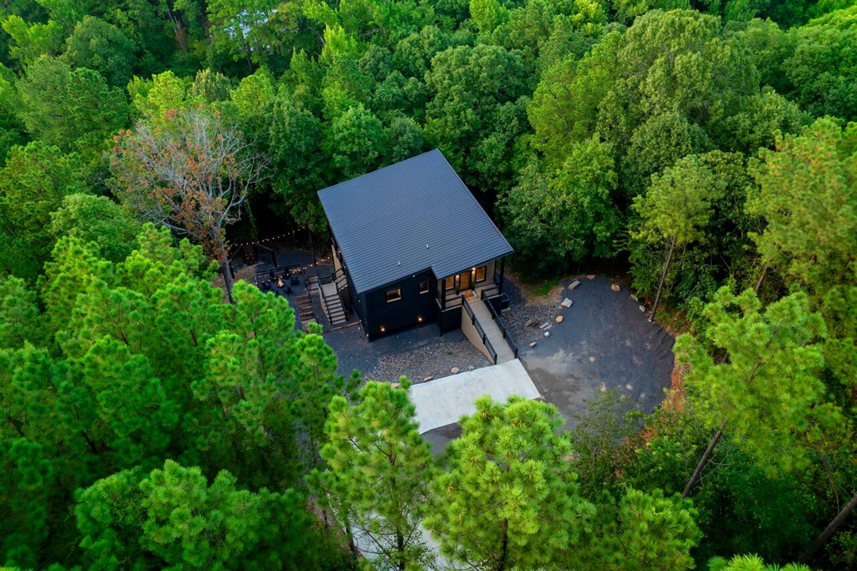 Aerial view of Honeycomb Hideout front, paved driveway & parking area.