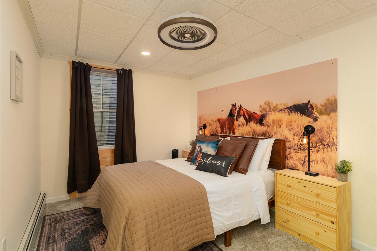 Relaxing Horse-Themed Retreat — A peaceful lower-level bedroom perfect for unwinding.